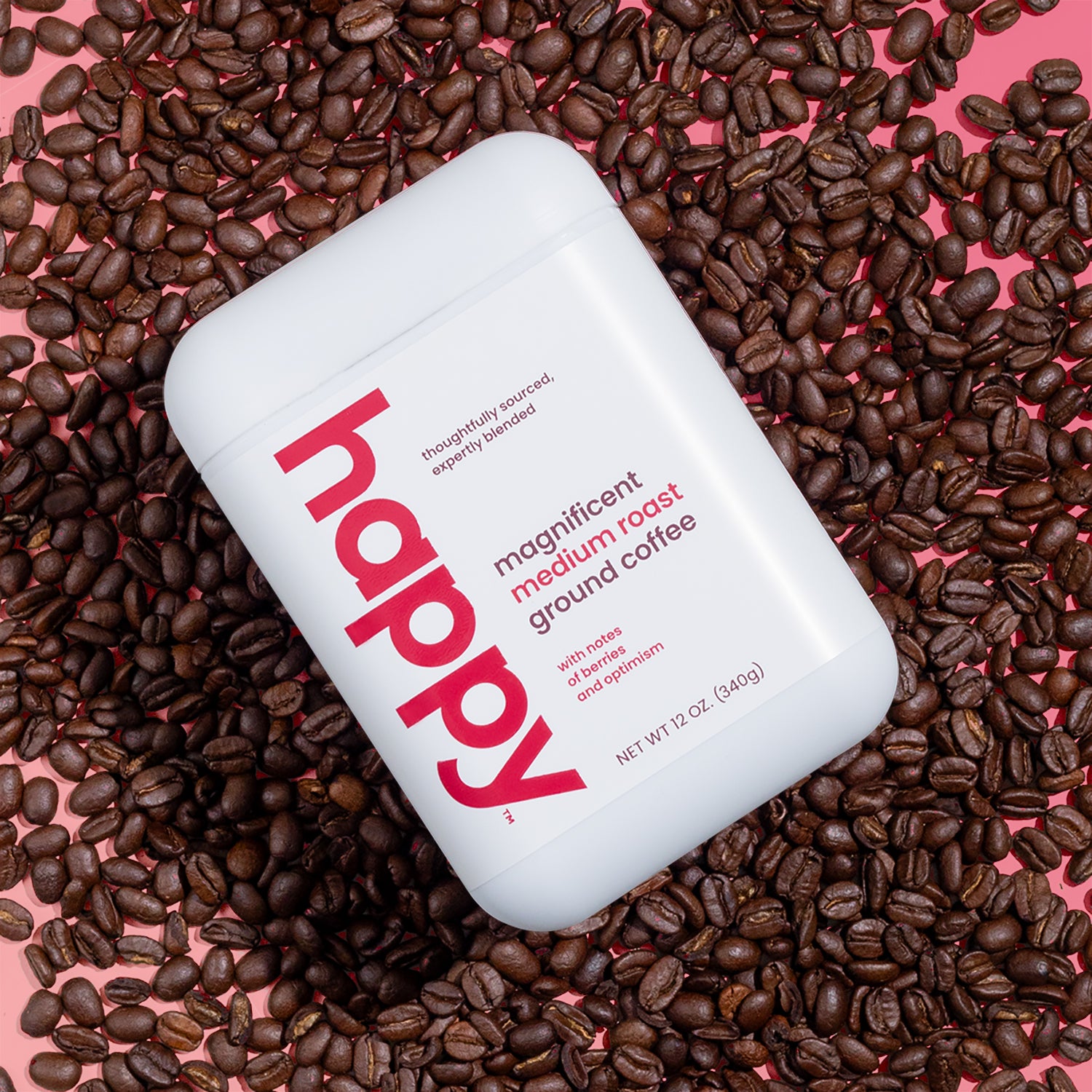 A container of Magnificent Medium roast ground coffee resting on a bed of coffee beans